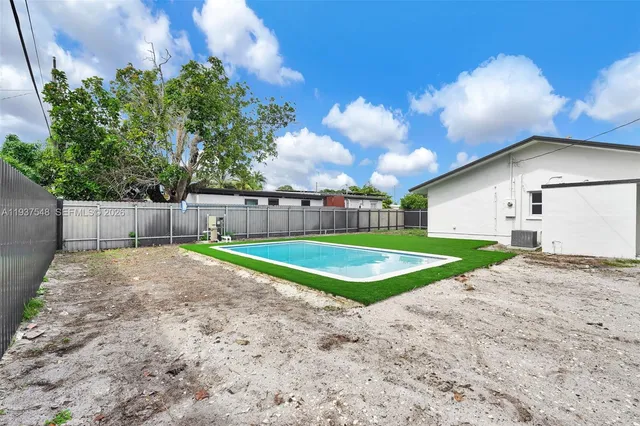 a view of a backyard with a trampoline