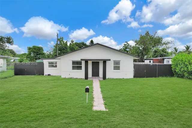 a view of a house with a yard