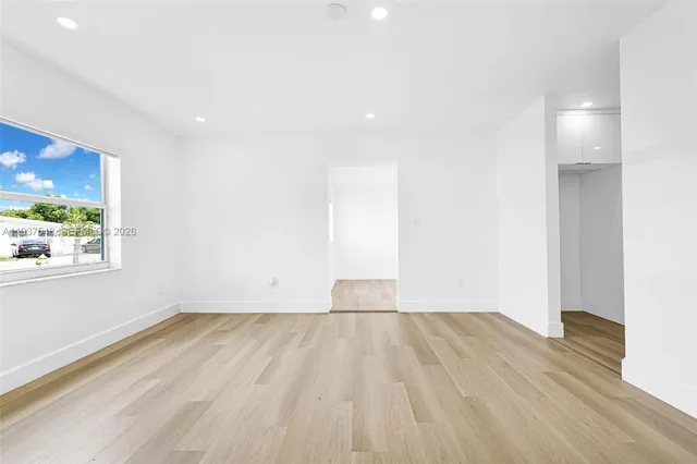 a view of room with window and wooden floor