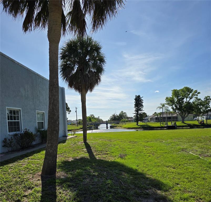 214 Boundary Boulevard, Unit B Rotonda West, FL 33947 - Photo 2 of 6 a view of a garden with a lake