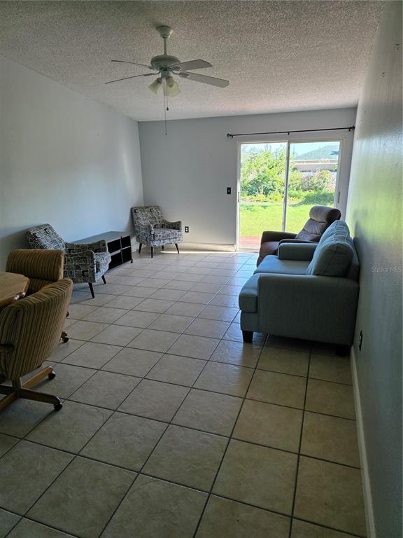 214 Boundary Boulevard, Unit B Rotonda West, FL 33947 - Photo 3 of 6 a living room with furniture and a window