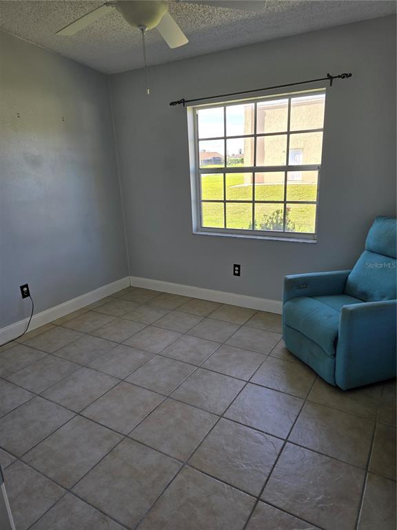 214 Boundary Boulevard, Unit B Rotonda West, FL 33947 - Photo 4 of 6 a living room with a window
