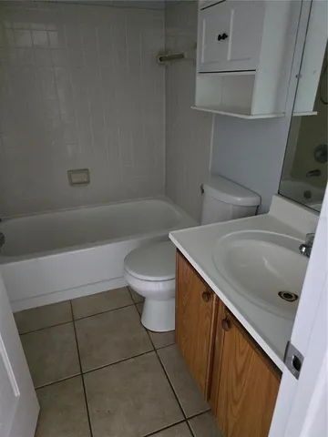 a bathroom with a sink a toilet and bathtub