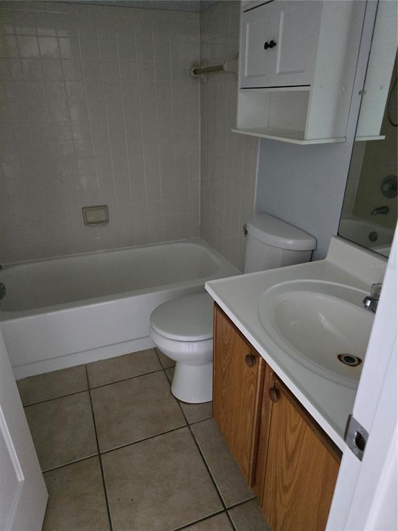214 Boundary Boulevard, Unit B Rotonda West, FL 33947 - Photo 6 of 6 a bathroom with a sink a toilet and bathtub