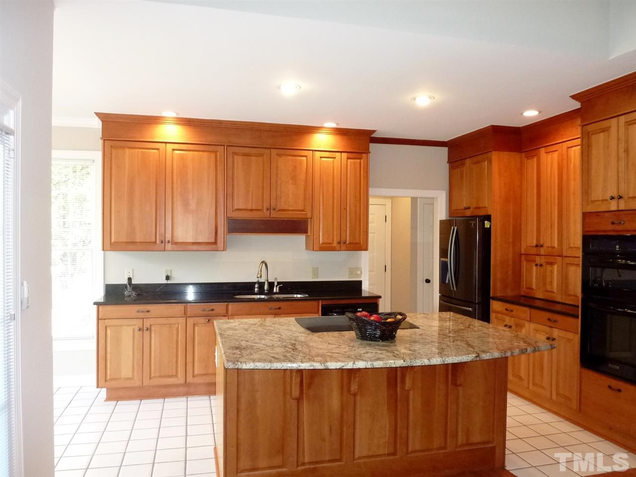 1519 Pleasant Green Road Durham, NC 27705 - Photo 11 of 30 Natural Cherry cabinets with granite counter tops, appliance cupboards. Wall oven and Microwave, KitchenAid appliances. Open to Great room and Breakfast room.