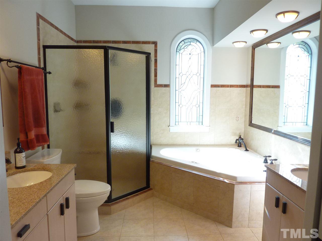 1519 Pleasant Green Road Durham, NC 27705 - Photo 19 of 30 Walk in shower, leaded window, tub and separate vanities!