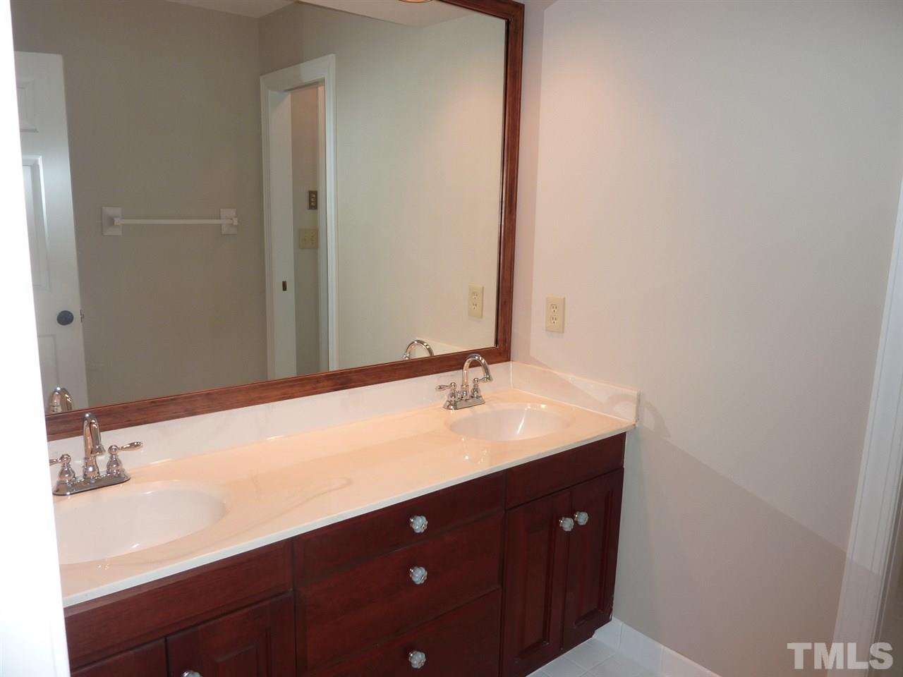 1519 Pleasant Green Road Durham, NC 27705 - Photo 23 of 30 Dual vanity and pocket door to tub and toilet. Large linen closet.