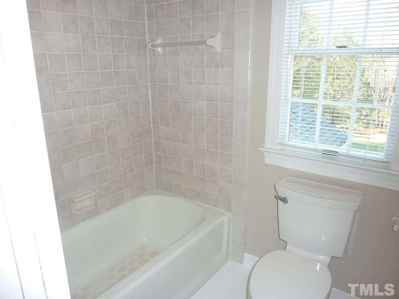1519 Pleasant Green Road Durham, NC 27705 - Photo 24 of 30 Tile tub and shower, tile floors, pocket door