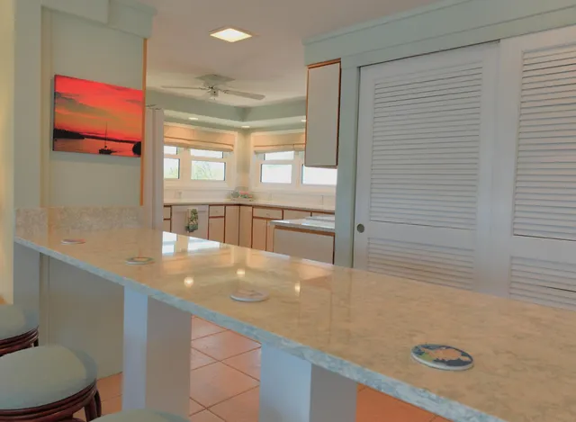 a kitchen with stainless steel appliances granite countertop a sink and a wooden cabinets