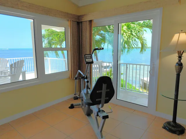 a view of a workspace with a window and a chair