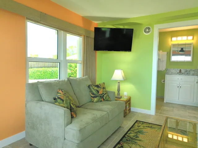 a living room with couches and a flat screen tv