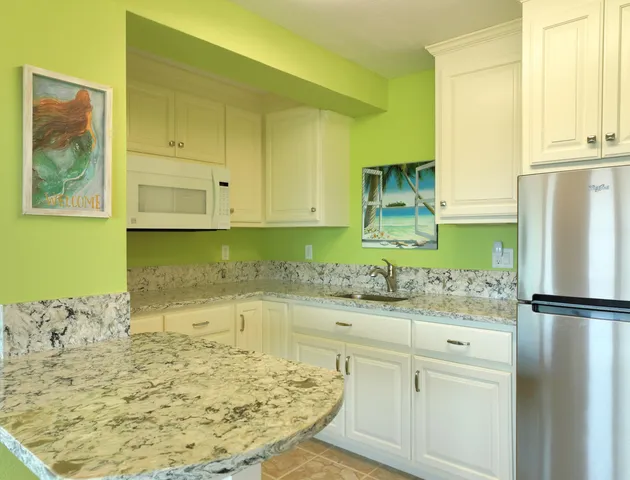 a kitchen with a refrigerator and cabinets