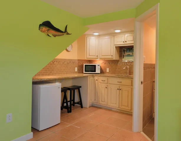 a kitchen with stainless steel appliances kitchen island a refrigerator sink and stove