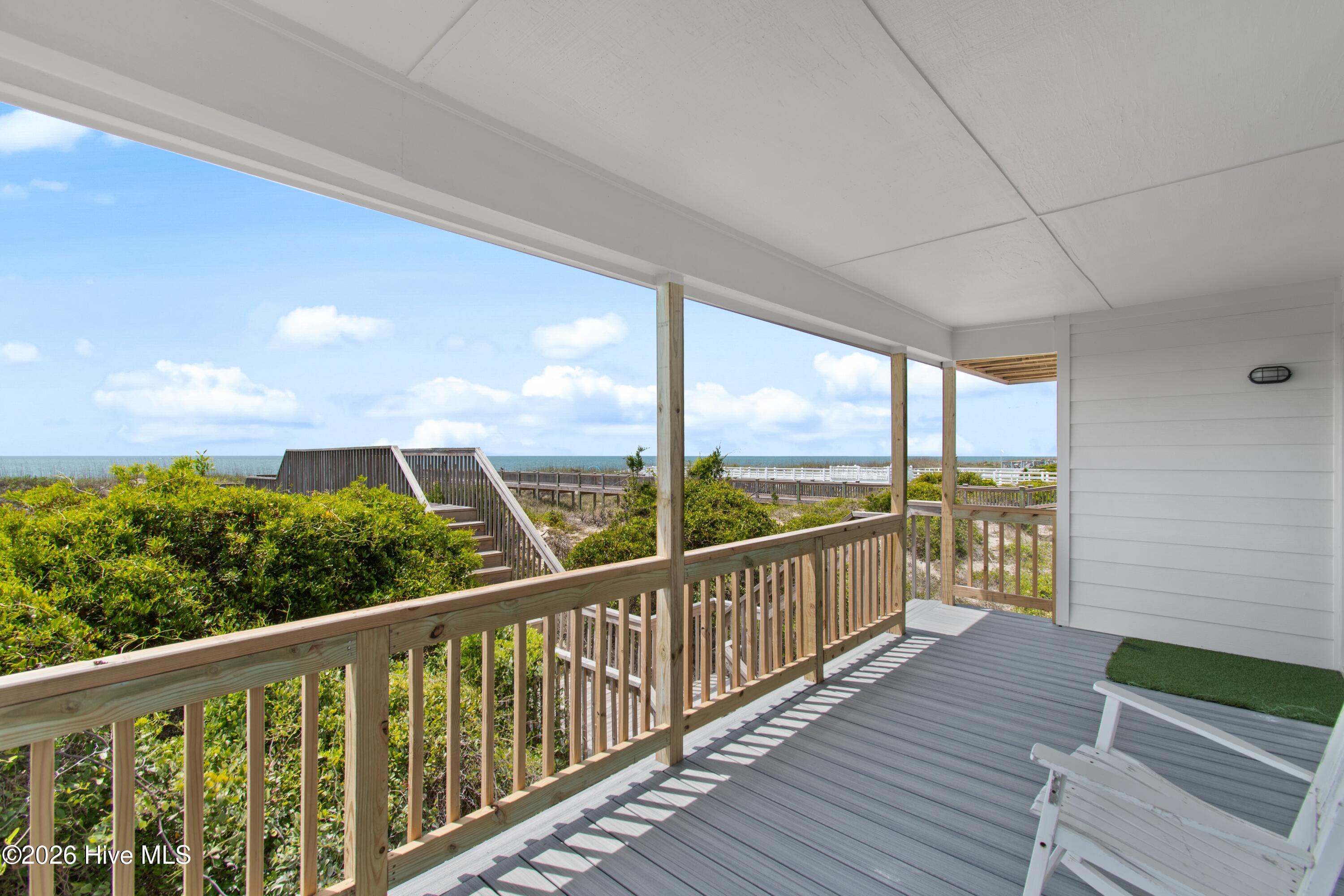 645 Caswell Beach Road Oak Island, NC 28465 - Photo 6 of 77 Covered Rocking Porch
