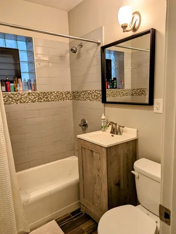 a bathroom with a sink a mirror and a toilet