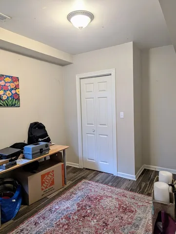 a bedroom with a bed and a dresser in it