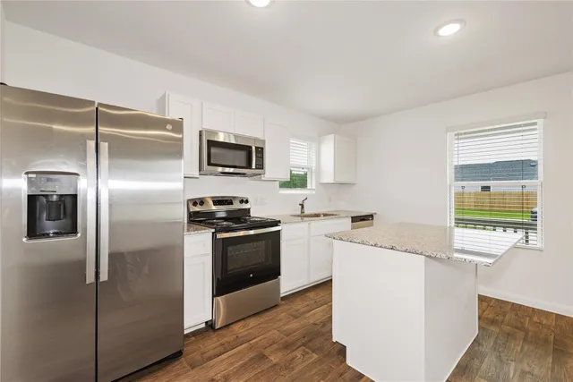 a kitchen with a refrigerator stove and sink