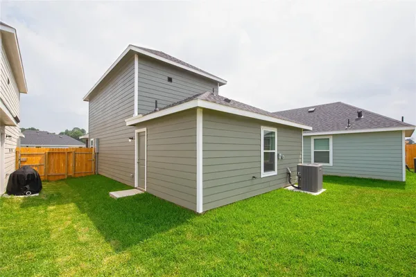 a view of a backyard with a small cabin and a chair
