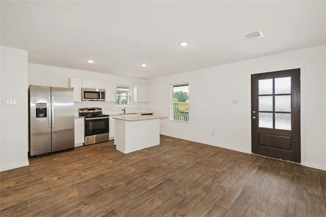 a kitchen with stainless steel appliances a refrigerator sink and stove
