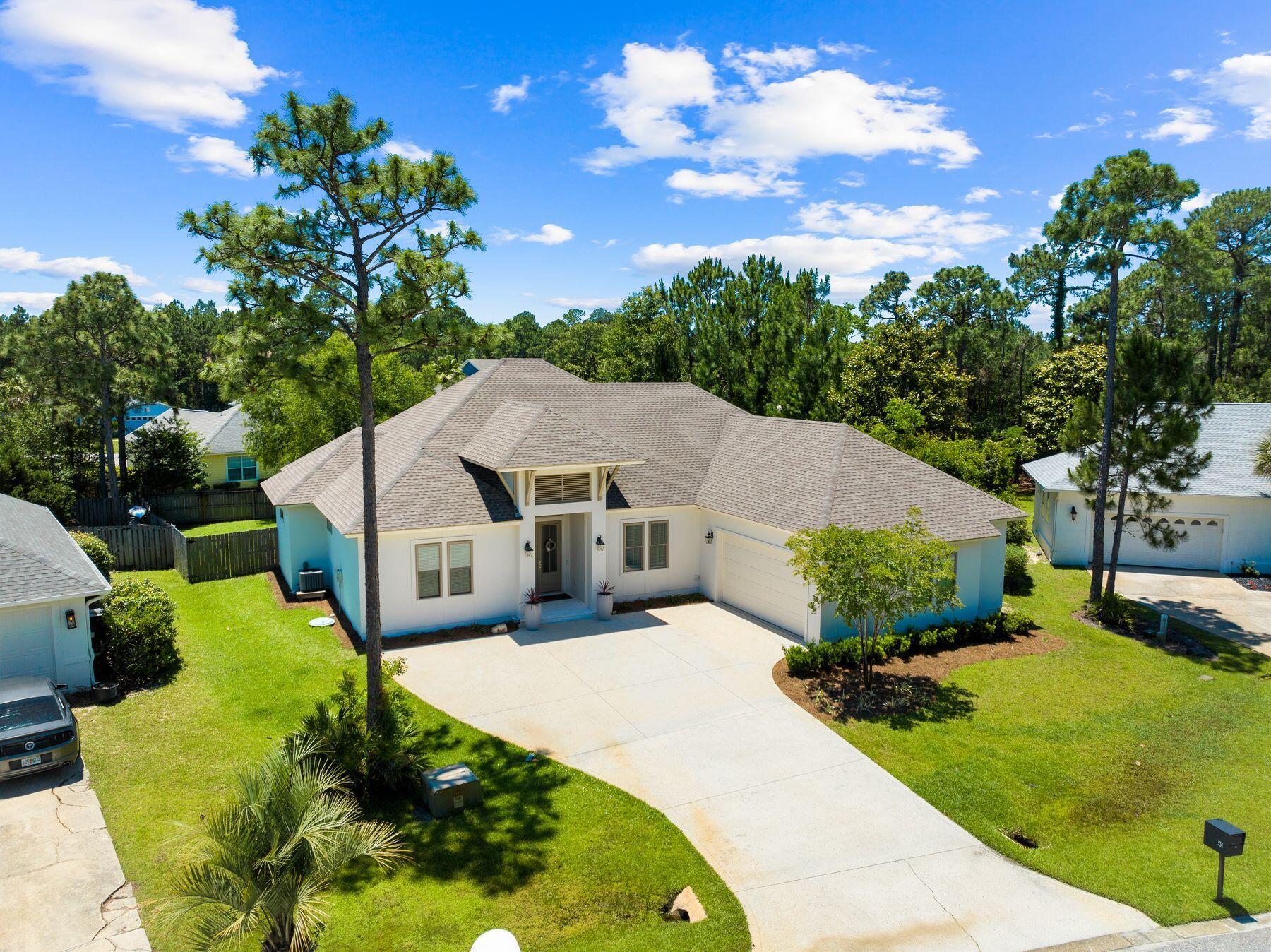 a aerial view of a house with a yard and potted plants