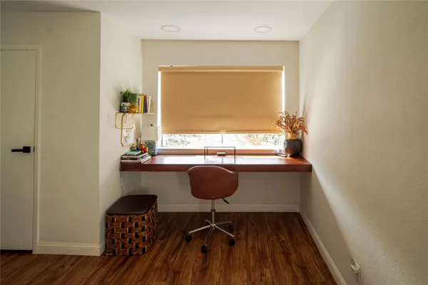 a dining room with furniture and a window