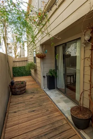 a view of a roof deck with wooden floor and fence