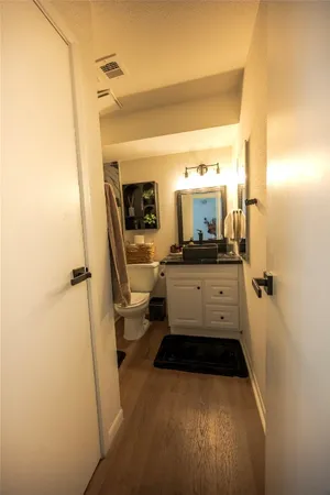 a hallway with wooden floor chandelier