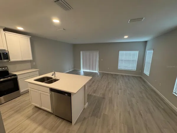 a kitchen that has a sink and a stove top oven