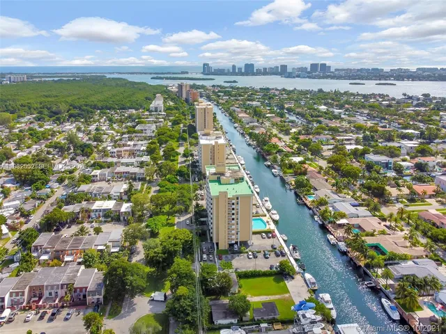 a view of a terrace with lawn chairs and wooden floor
