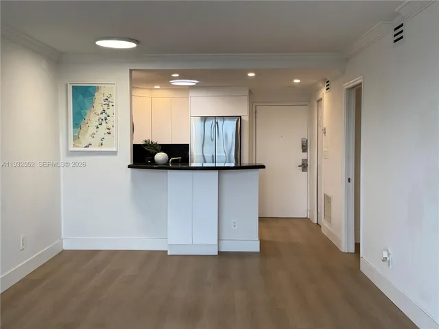 a kitchen with a refrigerator and a sink