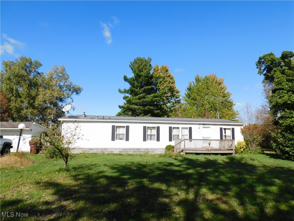 5059 Leon Road Andover, OH 44003 - Photo 1 of 18 Manufactured / mobile home with a front yard and a deck