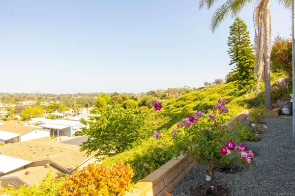 a view of house with an entryway and stairs