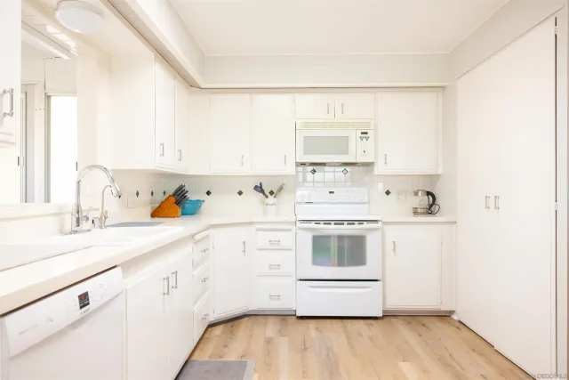 a kitchen with a sink and a refrigerator