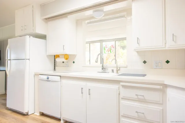 a view of a kitchen with a dining table and chairs