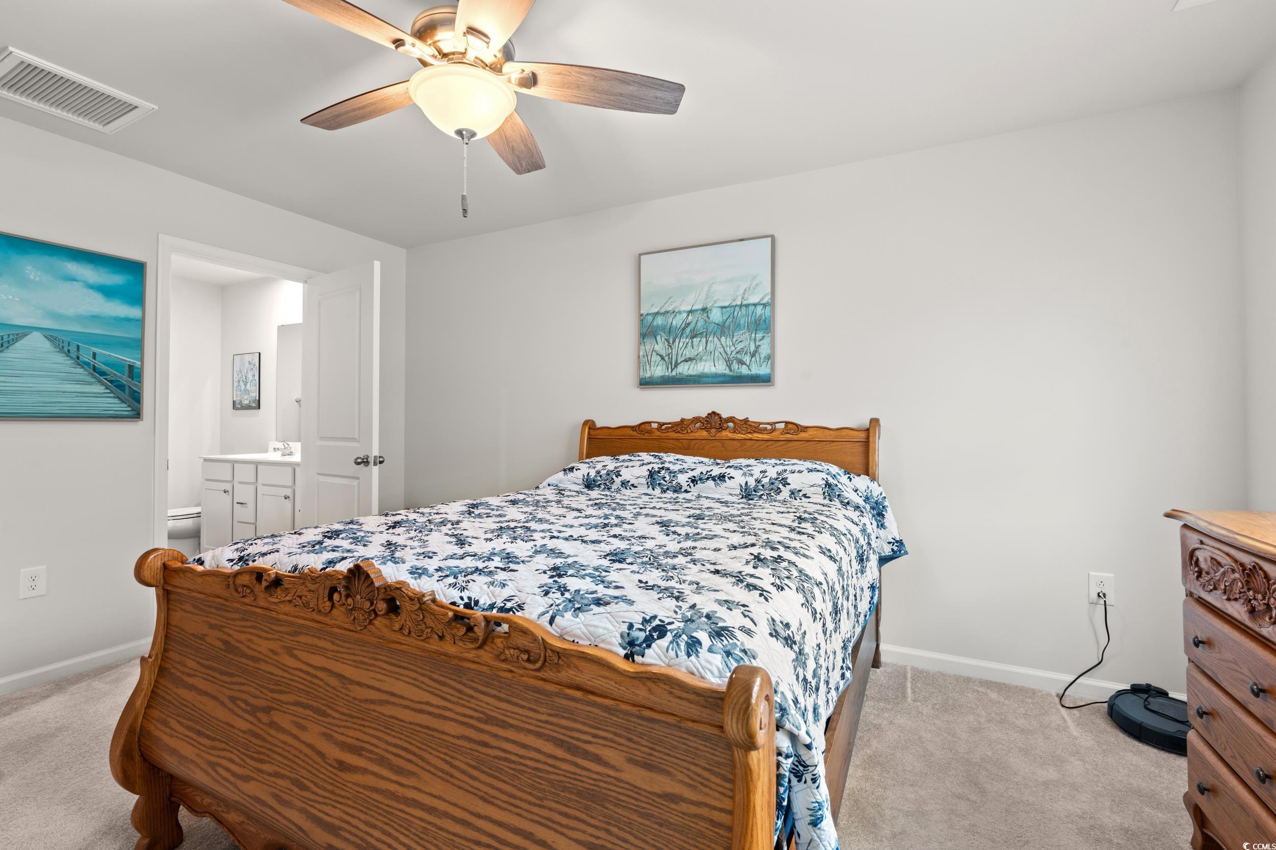 301 Granada Street, Unit D Myrtle Beach, SC 29579 - Photo 11 of 33 Bedroom with light colored carpet, ceiling fan, and connected bathroom