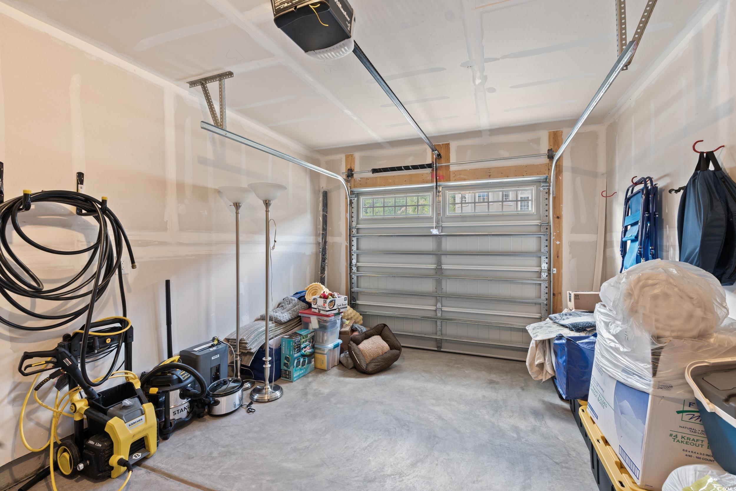 301 Granada Street, Unit D Myrtle Beach, SC 29579 - Photo 23 of 33 Garage featuring a garage door opener