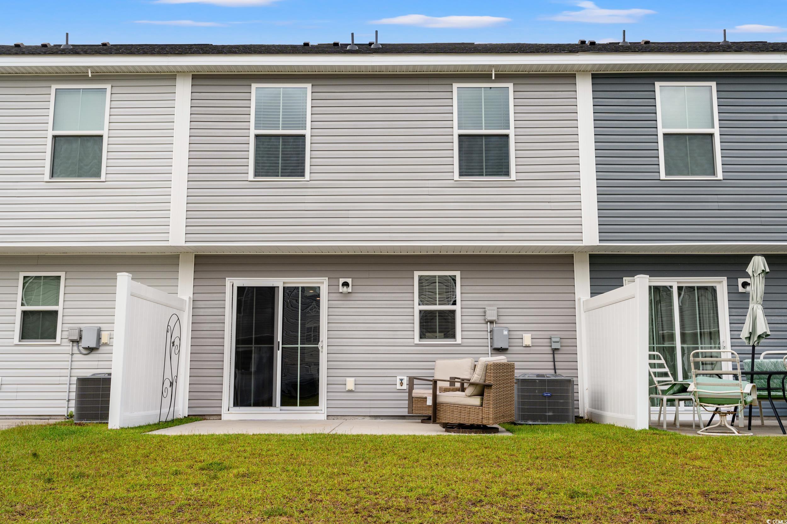 301 Granada Street, Unit D Myrtle Beach, SC 29579 - Photo 26 of 33 Back of house featuring a patio and a yard