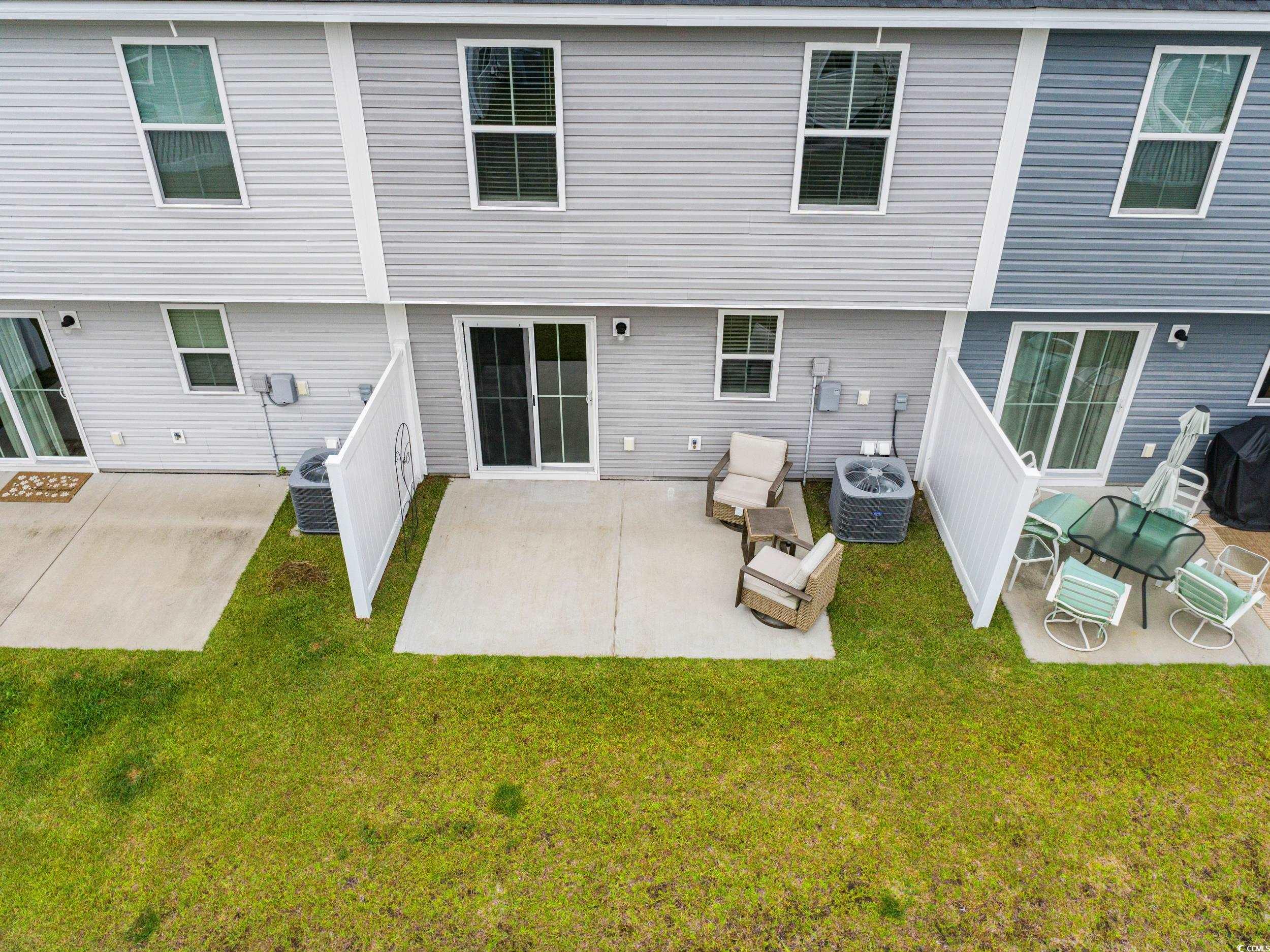 301 Granada Street, Unit D Myrtle Beach, SC 29579 - Photo 27 of 33 Rear view of property with a patio area and a lawn