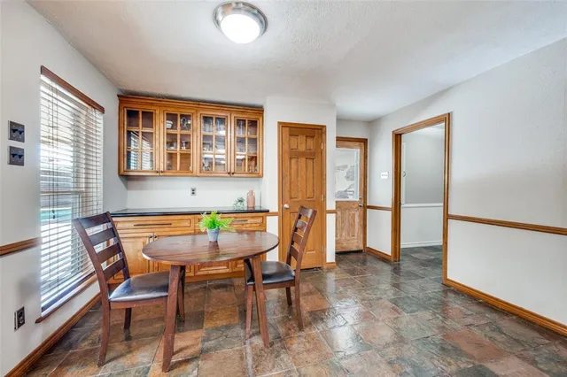 a dining room with furniture and window