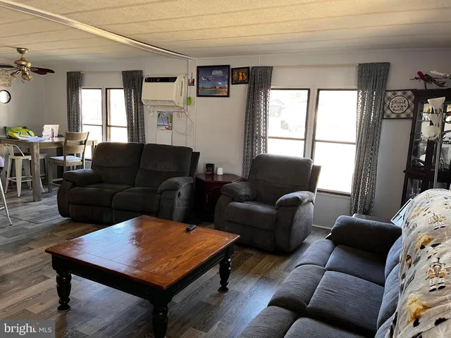 a living room with furniture a window and a flat screen tv