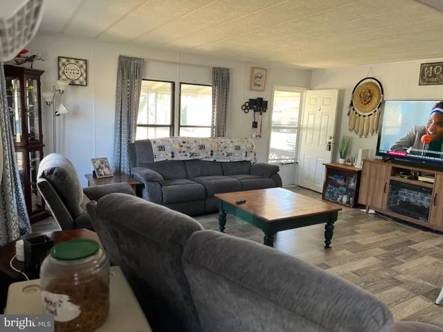 a living room with furniture a fireplace and a window