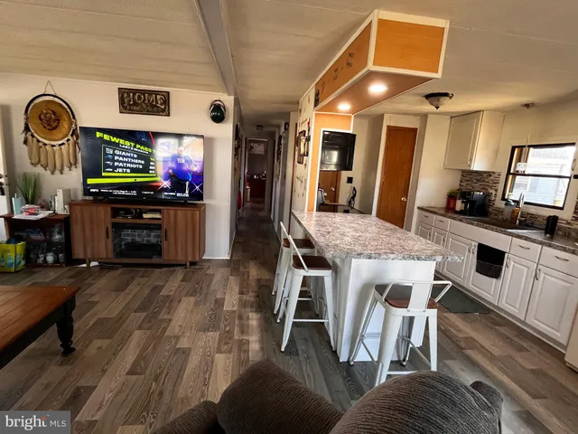 a living room with furniture and flat screen tv