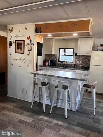 a kitchen with stainless steel appliances granite countertop a sink and a refrigerator
