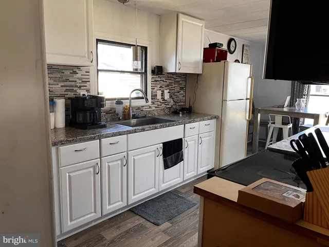 a kitchen with a refrigerator and a sink