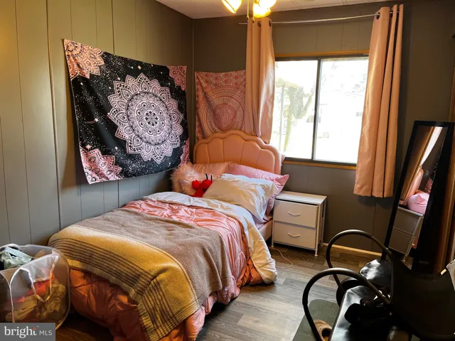 a bedroom with bed and a window