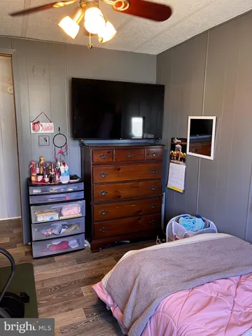 a bedroom with a bed and flat screen tv
