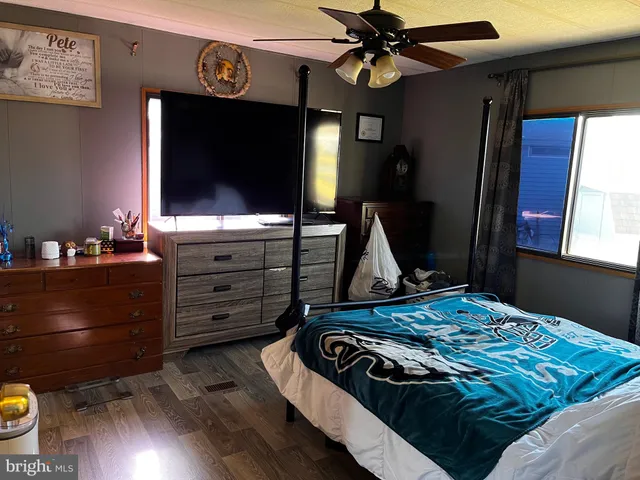 a bedroom with a bed and flat screen tv