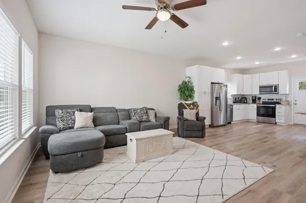 a living room with furniture and a chandelier