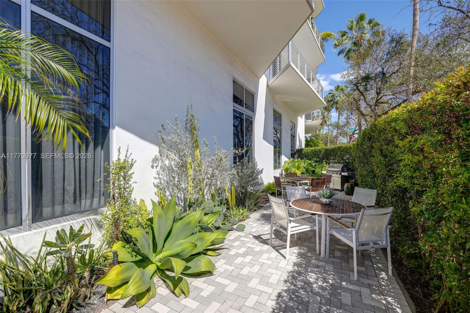 The Meridian Miami Beach, FL 33139 - Photo 11 of 27 a backyard with a table and chairs and a flower pot