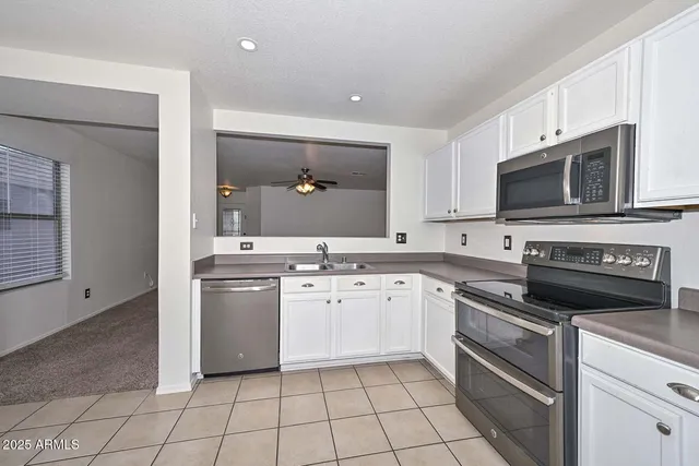 a kitchen with a stove a sink and a microwave